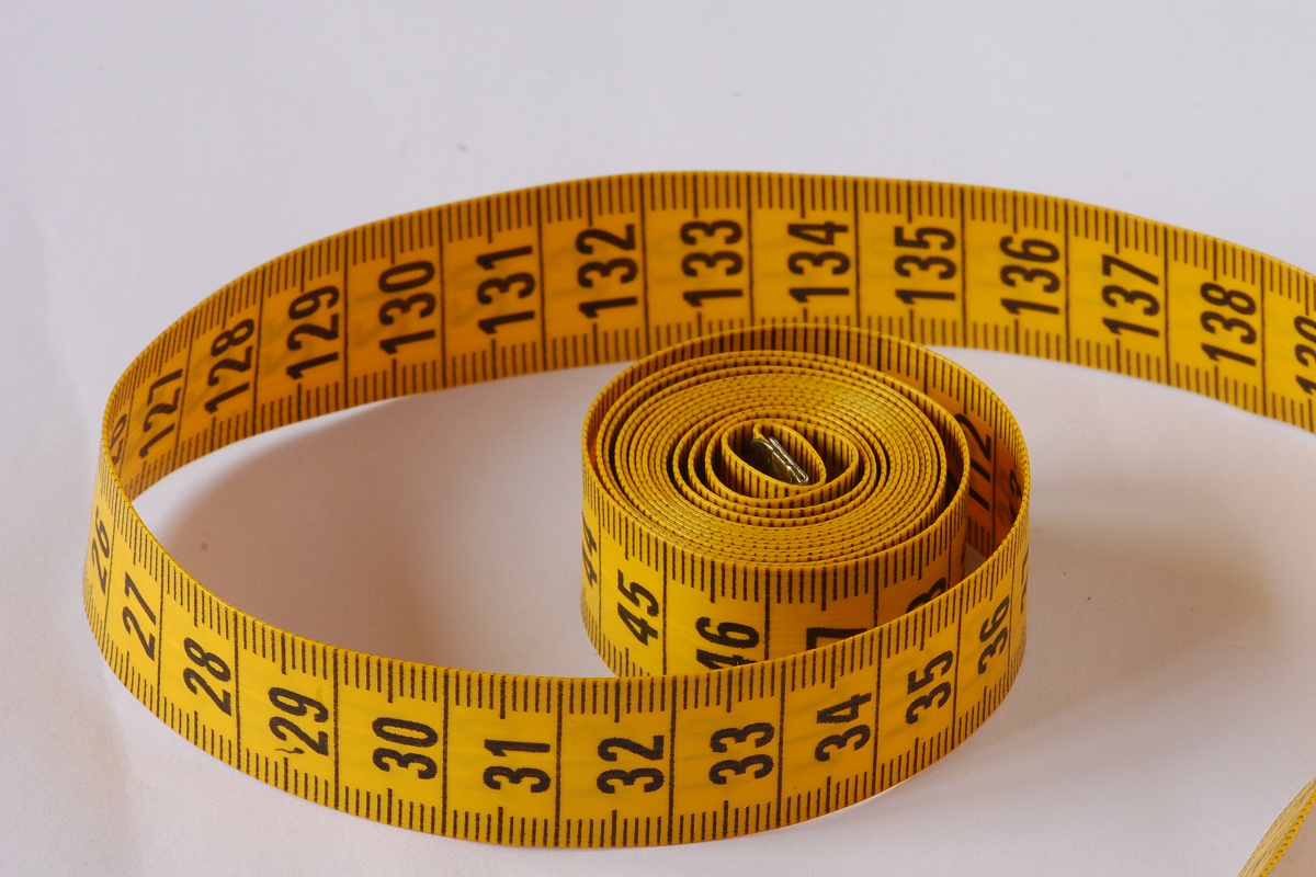 A yellow tape measure coiled up.